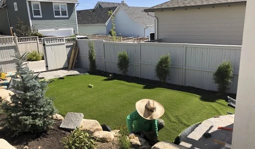 laying fake grass on dirt